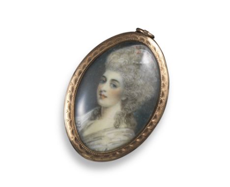 A George III portrait miniature pendant, depicting a woman in profile, within engine-turned gold frame, glazed locket compart