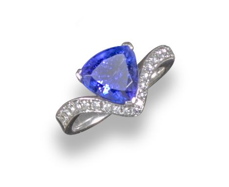 A tanzanite and diamond ring, the white gold ring of chevron design and set with graduated circular-cut diamonds and a triang