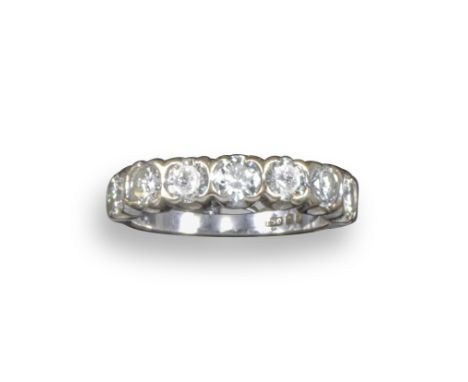 A diamond seven-stone half-hoop ring, the seven round brilliant-cut diamonds are set in 18ct white gold, size K