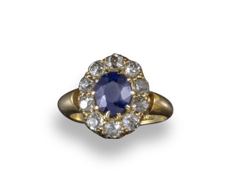A Victorian sapphire and diamond cluster ring, the oval-shaped sapphire set within a surround of old circular-cut diamonds in
