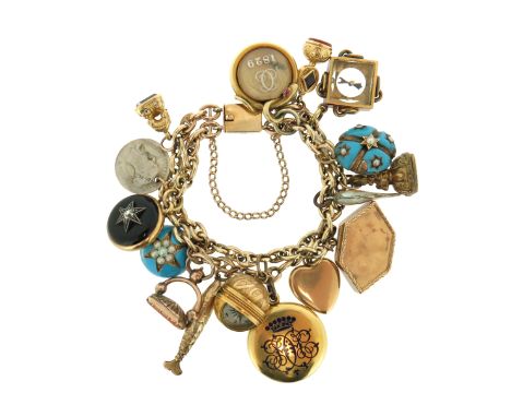 A gold charm bracelet, suspending assorted charms including a spinning compass charm, a garnet and diamond locket, a gold hea