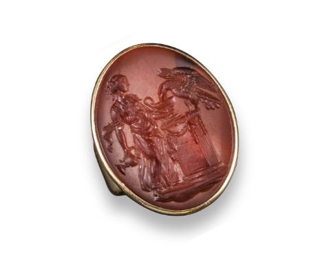 A 19th century oval carved carnelian intaglio, Zeus transformed to an eagle and Hebe offering a cup on a plinth,  2.7cm high,