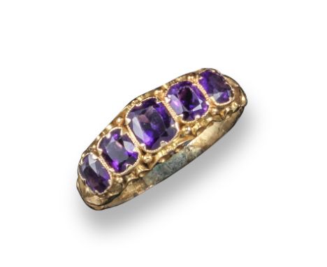 A 19th century amethyst half hoop ring, set in yellow gold scroll mount, size Q