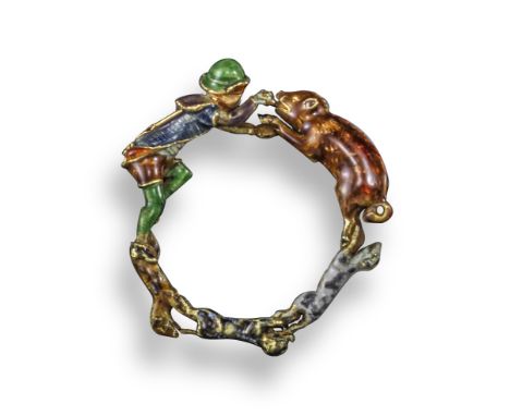 A whimsical antique enamel ring, depicting a gentleman in traditional medieval attire, with a wild boar hunted by three dogs,