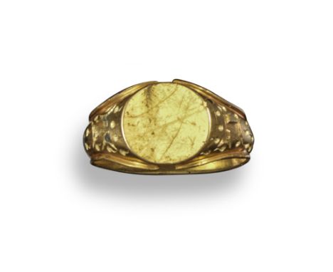 A medieval-style gold signet ring, c1500, engraved with a Tau cross surrounded by droplets depicting the tears or blood of Ch