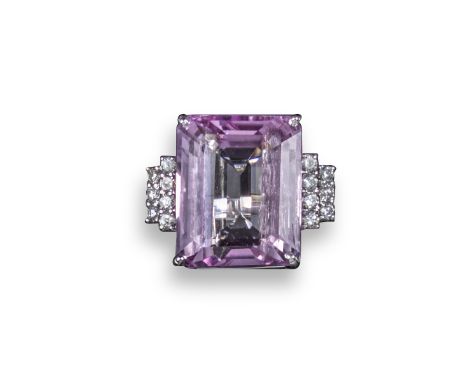 A kunzite and diamond ring, the emerald-cut kunzite weighs approximately 19.90cts and is set with seven circular-cut diamonds