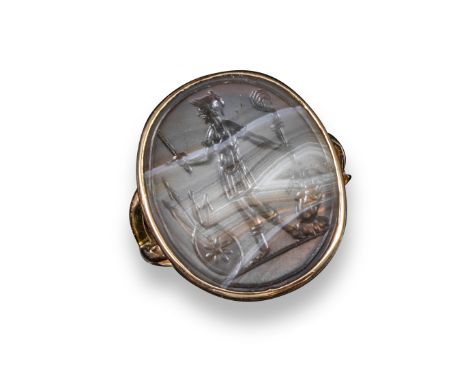 A 17th century carved agate oval intaglio, depicting a standing Mars holding a sword in one hand and a flaming torch in the o
