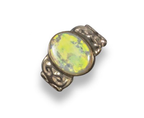 An opal single stone ring, the solid white opal is set in a 9ct scrolling gold mount, London hallmarks for 1990, size N