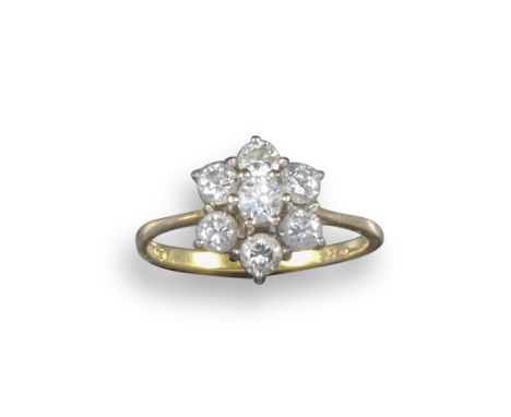 A diamond cluster ring, set with seven round brilliant-cut diamonds in platinum and yellow gold, size O 1/2