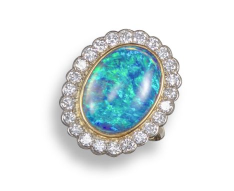 A black opal and diamond cluster ring, the oval opal cabochon is set within a surround of circular-cut diamonds in yellow and