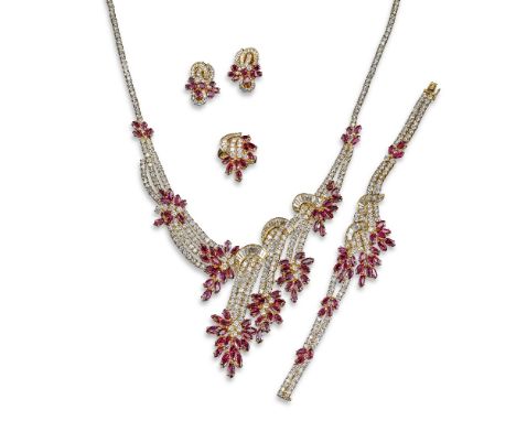 A ruby and diamond-set suite of jewellery, comprising a necklace, bracelet, earrings and a ring. The necklace of foliate spra