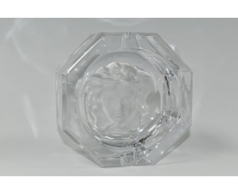 A ROSENTHAL VERSACE MEDUSA LUMIERE CUT CRYSTAL ASHTRAY,  of octagonal form, with a frosted cameo glass Versace emblem to the 