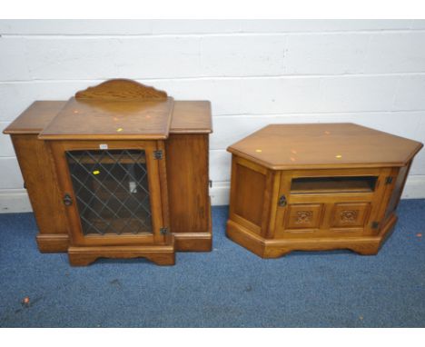 A LATE 20TH CENTURY OAK MEDIA CABINET, the hinged lid above a single lead glazed door, a single cupboard door to each side, e