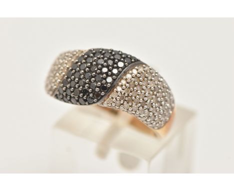 A 9CT GOLD DIAMOND DRESS RING, pave set with colourless single cut diamonds and pave set round brilliant cut black diamonds, 