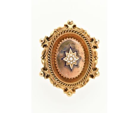 A VICTORIAN YELLOW METAL ETRUSCAN PHOTO PENDANT, of an oval form, displaying a central blue enamel star set with a cluster of