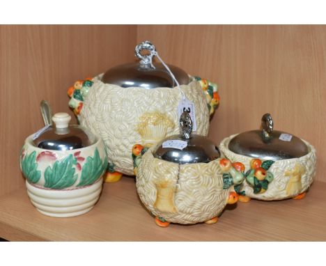 A GROUP OF CLARICE CLIFF CELTIC WARE, comprising a 'Celtic Harvest' biscuit barrel and two preserve pots, each moulded and pa