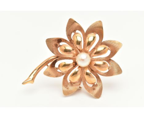 A YELLOW METAL FLOWER BROOCH, open work textured and polished finish flower, set with a central cultured pearl, fitted with a