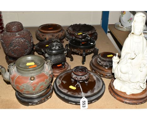 A COLLECTION OF CARVED WOOD ORIENTAL POT STANDS AND ORNAMENTS, comprising fourteen carved assorted circular pot stands, a sma