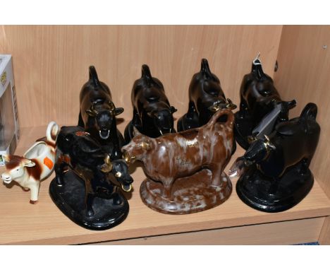 A GROUP OF CERAMIC COW CREAMERS to include six black cows with gilt embellishment and stoppers, a mottled brown creamer with 