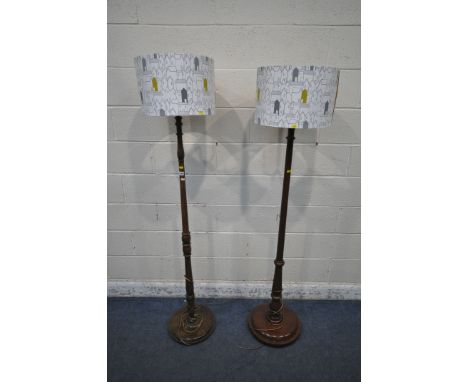 AN OAK STANDARD LAMP, with turned and tapered upright, on a circular base, height to fitting 156cm, along with a similar maho