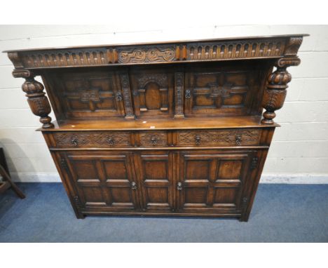 A 20TH CENTURY OAK COURT CUPBOARD, with scrolled and foliate carved details, bulbous turned supports, fitted with an arrangem