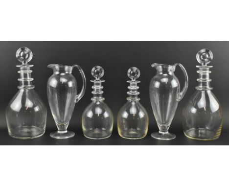 Hugh Johnson Collection - a collection of four ring decanters and two glass jugs. The ring decanters comprising two larger an