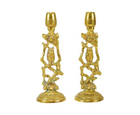 A pair of late 19th / early 20th century owl themed candlestick holders. Brass construction, with central owl design and acor