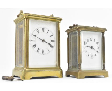 Two early 20th century brass and bevelled glass carriage clocks. The lot comprising a larger carriage mantle clock featuring 