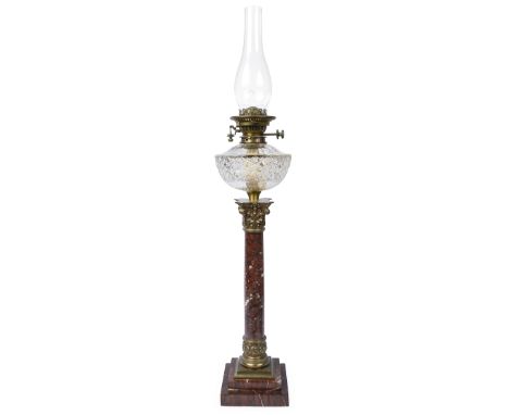A late 19th century ormolu and red marble Corinthian column oil lampfitted with a cut glass reservoir and Hink's Duplex Paten