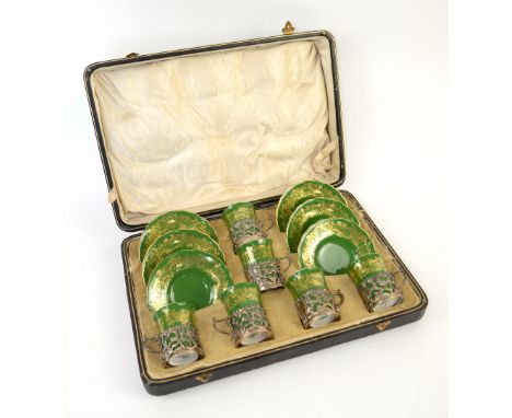 A set of six Coalport porcelain cups and saucers with pierced silver liners, housed in a velvet lined fitted case with presen