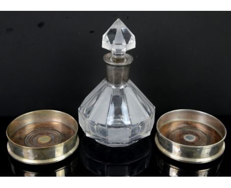 Pair of silver bottle coasters, London 2001 and an etched glass decanter with white metal mount.Sold on Behalf of Princess Al