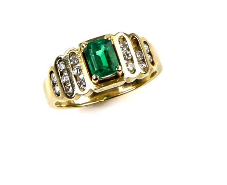 Emerald and diamond ring, central step cut emerald, estimated weight 0.67 carats, with round brilliant cut set diamond should