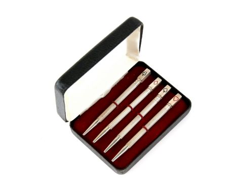 Cased set of silver and enamel bridge pencils .    