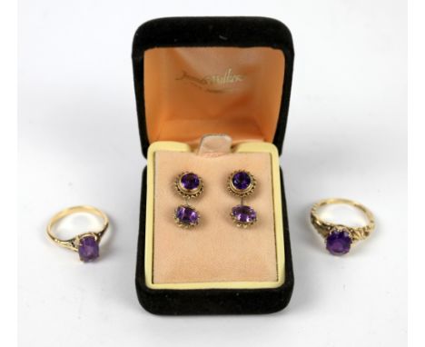 Two single stone amethyst rings and two pairs of amethyst stud earrings, all in gold mounts  .    