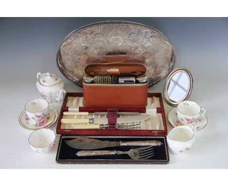 An assortment of silver plated wares to include an oval gallery tray, a cased carving set, an oval frame along with a gentlem