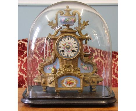 A 19th Century French gilt brass eight day mantle clock, the Roman numeral porcelain dial with movement striking on a bell an