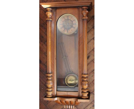 A walnut Vienna regulator, with Roman numeral chapter ring with floral centre and movement striking on a gong, 92cm 