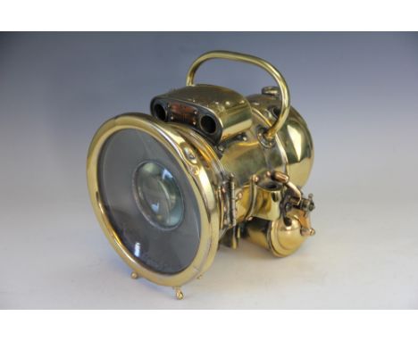 Motoring interest: A Lucas Motolite Acetylene brass head lamp, No 386, with original canister, (crack to glass), 27cm long x 