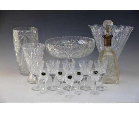 A selection of glass ware to include; a silver collared decanter and stopper, a glass lamp and faceted glass shade, a large V