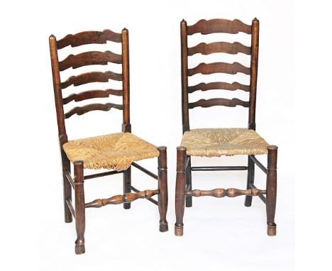 A matched set of six 19th century oak and ash ladder back dining chairs, with rush seats, on turned legs (6)