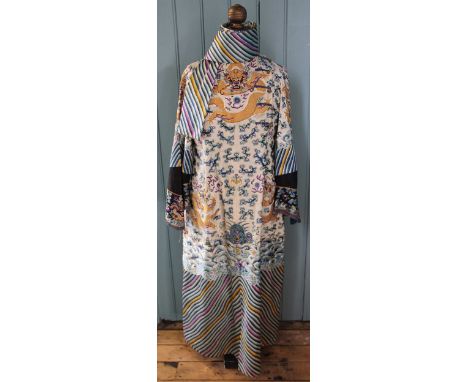 A Chinese silk embroidered long sleeved robe, the heavily embroidered gown decorated with Chinese Deity Lions, dragons, bats 