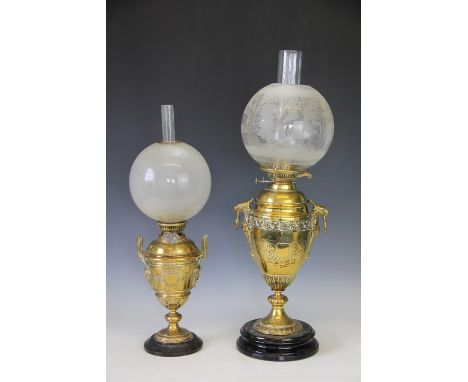 A Victorian brass oil lamp, the urn shaped base with eagles head ring handles, frosted glass shade and clear chimney, 68cm hi