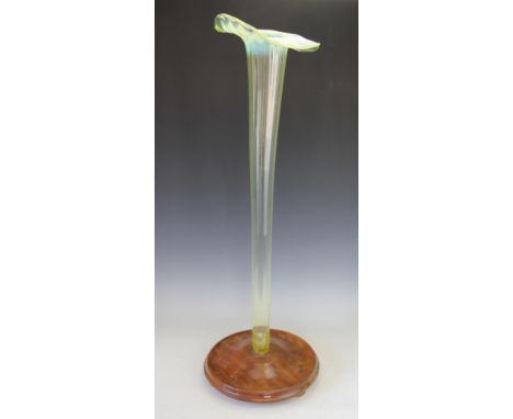 A large Stourbridge vaseline opal glass trumpet vase, circa 1890, ribbed form with flared lip, on wooden foot, 94.5cm high