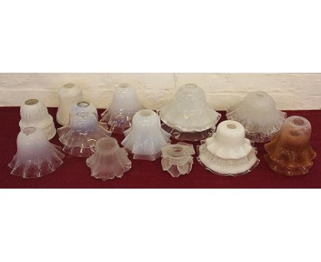 A collection of fourteen opaque and colourless glass lamp shades, each with crimped rim and some with spiral and textured det