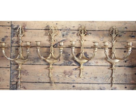 A set of four gilt metal two-branch light fittings, early 20th century, each in Edwardian garland style with acanthus wrapped