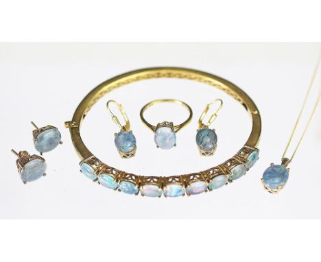 A collection of opal triplet and yellow metal set jewellery, to include; a hinged bangle, a pendant and chain, a ring, a pair