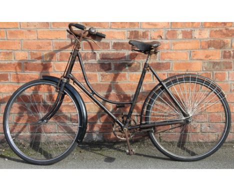 A vintage Ladies loop frame bicycle, possibly a Phillips, with skirt guard to rear wheel