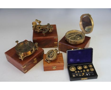 Four modern cased instruments, comprising a West of London style compass, a sextant, a larger compass and a military type com