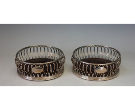 A pair of George III old Sheffield plate bottle coasters, Daniel Holy Wilkinson & Co, Sheffield circa 1800, with wire work ga