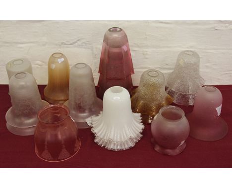 A set of three glass lamp shades with graded clear to cranberry colourway and etched lace detail along with textured examples